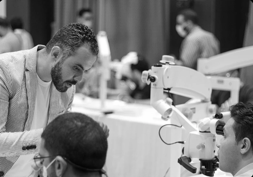 A dental trainer guiding participants in a clinical workshop